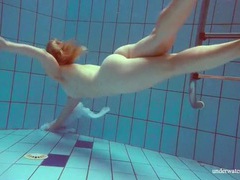 Find-Best-Pantyhose.com presents: Redhead goes for a nude swim in the pool